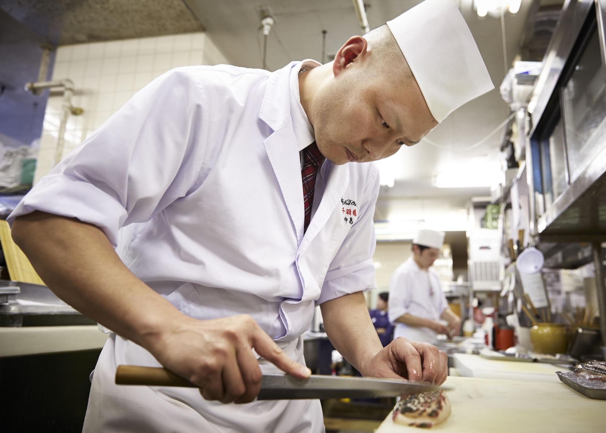 Hotel New Otani Hakata Fukuoka  Exterior foto A cook working in a restaurant kitchen